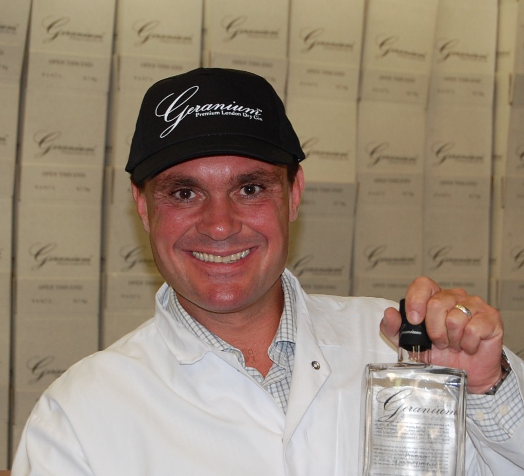 Henrik Hammer holding a bottle of Geranium Gin.